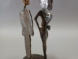 a statue of a man and a woman standing next to each other