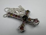 silver cross with multi colored stones on a white background