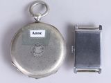 a silver pocket watch with a name tag attached to it