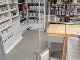 a table in the middle of a store with a lot of items on the shelves