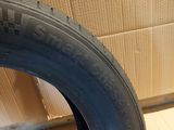 a close up of a tire on a wooden floor next to a cardboard box