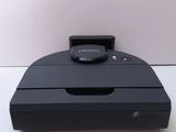 a black device that is sitting on a white table