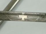 a close up of a metal object with a cross on it