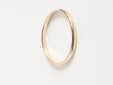a close up of a gold ring on a white surface