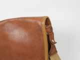 brown leather messenger bag on white background with strap