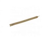 a close up of a gold bracelet on a white background