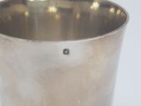 a silver cup that is sitting on a table
