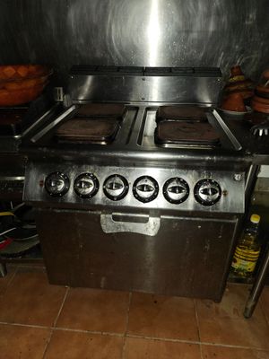 a lot of donuts on the stove in the kitchen