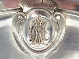 a close up of a silver plate with a crest on it