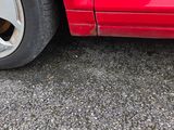 une voiture rouge garée sur le bord de la route