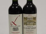 two bottles of wine sitting next to each other on a table