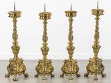 three gold candles are sitting next to each other on a table