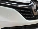 the front end of a white car with a black grille