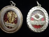 two silver and gold lockes with a picture of a woman and a man