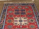 a red and blue area rug on the floor