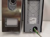 a metal door phone and a green cord connected to it