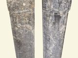 two pieces of stone sitting next to each other on a white surface
