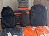many bags of luggage sitting on top of a cardboard box