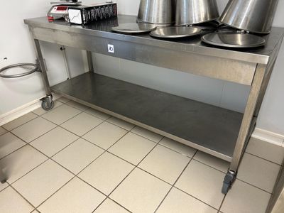 a stainless steel table with two pots on it
