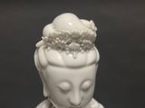 a close up of a white statue of a woman with a crown on her head