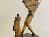 statue of a woman holding a bat next to a fire hydrant