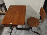 a small wooden table and two chairs in a room