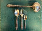 a spoon, fork, and spoon rest on a table
