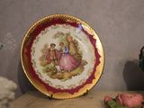 a plate with a painting on it sitting on a table