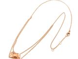 a gold necklace with a heart shaped pendant on a chain
