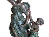 bronze statue of a woman with a child on a base