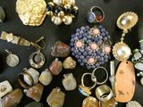 many different types of jewelry on a black table