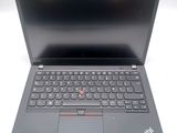 a close up of a laptop with a keyboard on a white surface