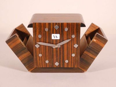 a wooden clock that is sitting on a table