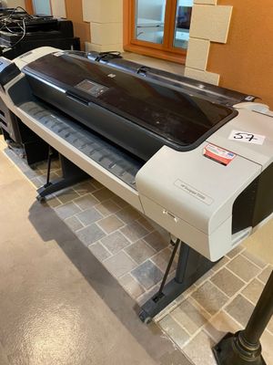 a large printer sitting on a stand in a room