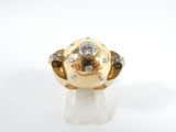 an image of a gold and diamond ring on a white surface