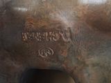 bronze statue of a horse with the name of a city on it ' s back