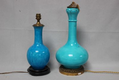 two blue vases sitting next to each other on a table