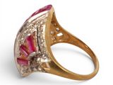 a close up of a gold ring with a pink stone and diamonds