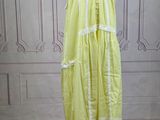 a dress on a mannequin stand in front of a wall