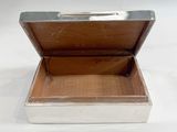 a silver box with a silver lid on a white surface