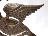 a bird that is sitting on top of a metal object