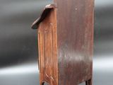 a small wooden cabinet with a door on it
