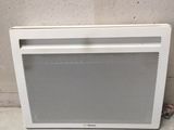 a white air conditioner sitting on the floor next to a wall