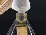 a bottle of perfume with a paper on top of it