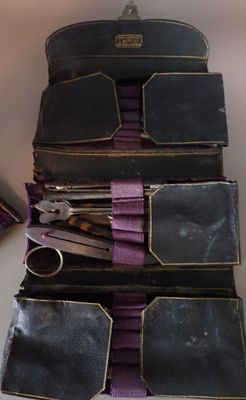 several pairs of scissors are sitting in a case on a table