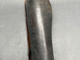 a picture of a hand holding a pair of boots