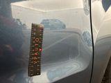 a measuring tape on the side of a car ' s door handle