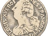 gros plan d'une pièce de monnaie sur laquelle figure un visage de femme