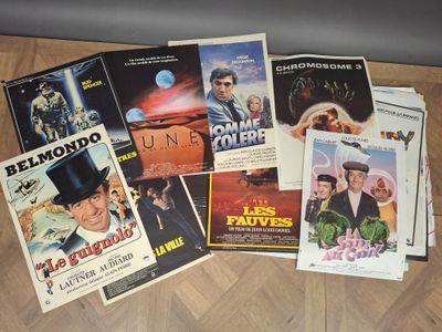 many movie posters on the floor of this room