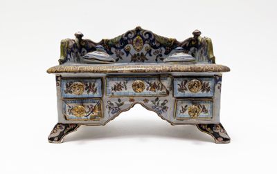 a small blue and white desk with a clock on it